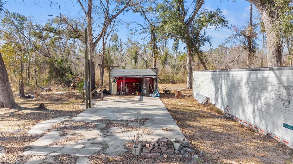 1650 Lyman Hendry Road, Unit 1 Perry, FL 32347 - Photo 17 of 30 a view of a street with along trees
