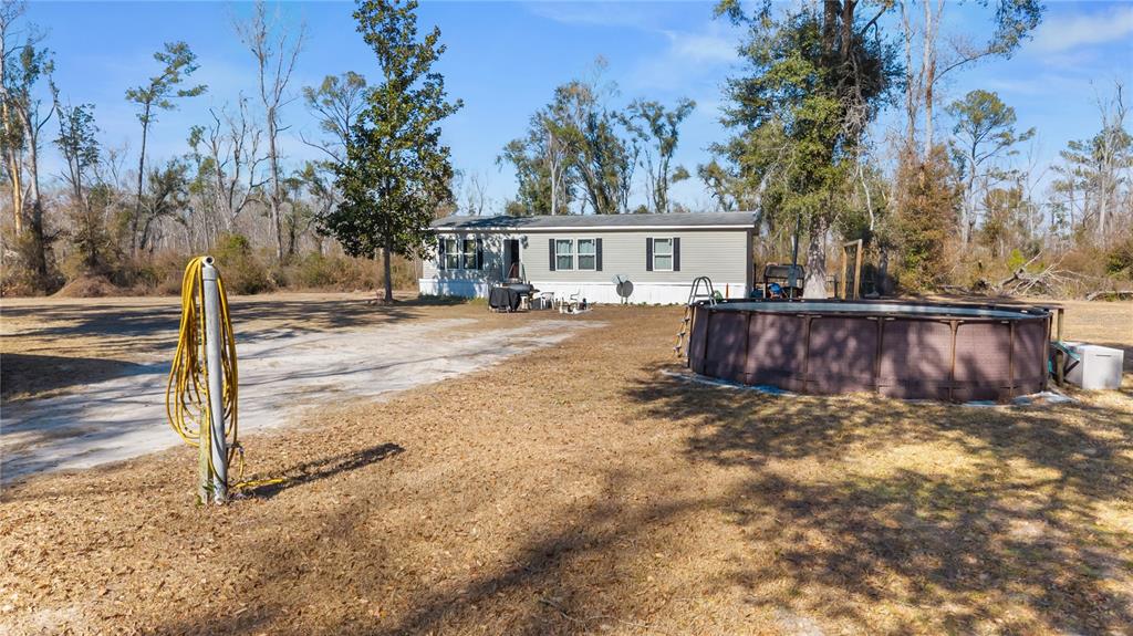 1650 Lyman Hendry Road, Unit 1 Perry, FL 32347 - Photo 2 of 30 a view of a house with a tree next to a road