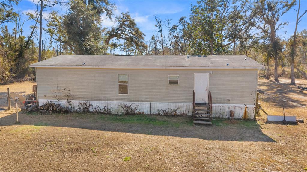 1650 Lyman Hendry Road, Unit 1 Perry, FL 32347 - Photo 21 of 30 a view of a house with a yard