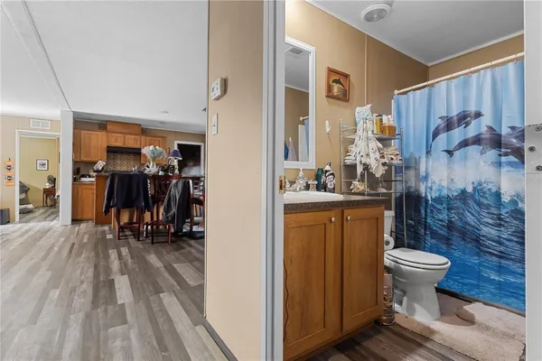 a bathroom with a granite countertop sink a toilet and a mirror