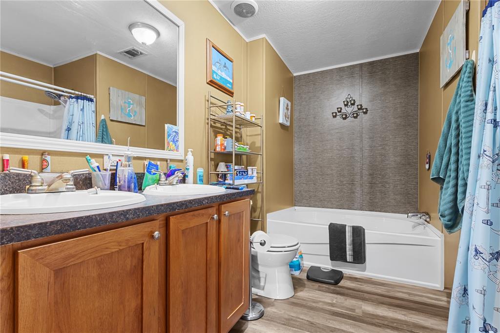 1650 Lyman Hendry Road, Unit 1 Perry, FL 32347 - Photo 8 of 30 a bathroom with a sink toilet and shower