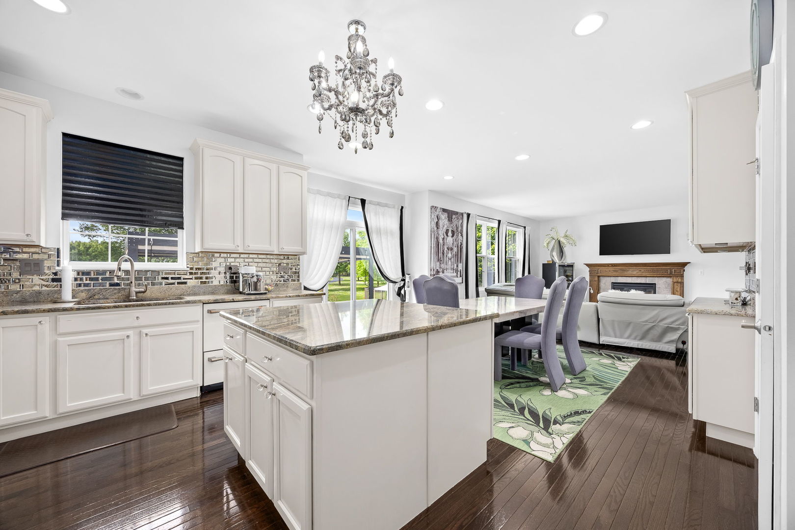 2297 Deerpath Road Bolingbrook, IL 60490 - Photo 15 of 46 a kitchen with furniture a center island wooden floor and a window