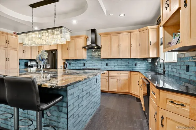 a kitchen with granite countertop a sink a counter top space and stainless steel appliances