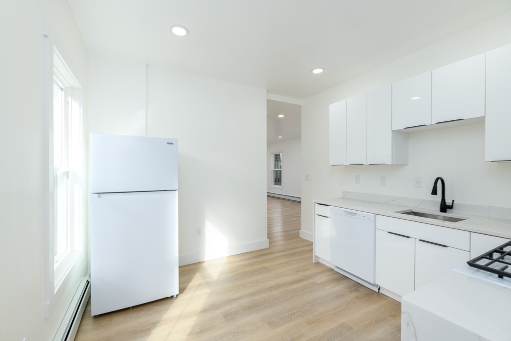 33 Florence Street Worcester, MA 01610 - Photo 16 of 36 a kitchen with a refrigerator sink and cabinets