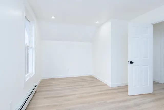 a view of room with wooden floor