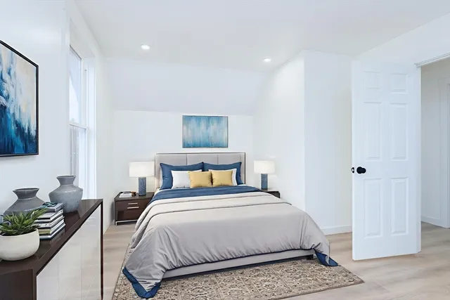 a bedroom with a bed and a couch