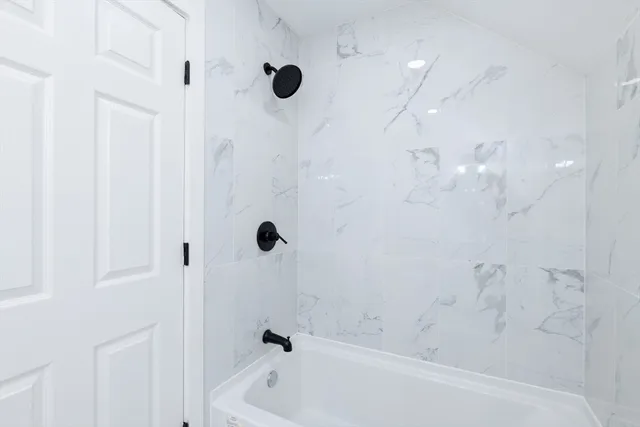a bathroom with a bathtub and shower