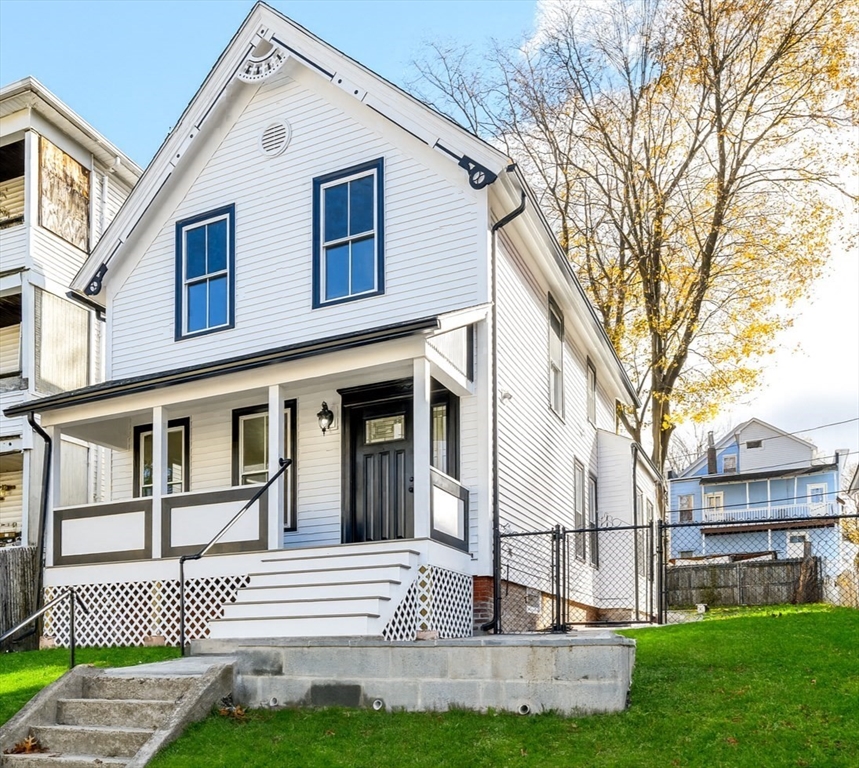 33 Florence Street Worcester, MA 01610 - Photo 3 of 36 a front view of a house with a yard