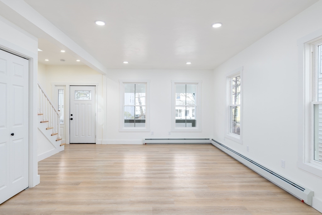 33 Florence Street Worcester, MA 01610 - Photo 8 of 36 a view of an empty room with wooden floor and a window