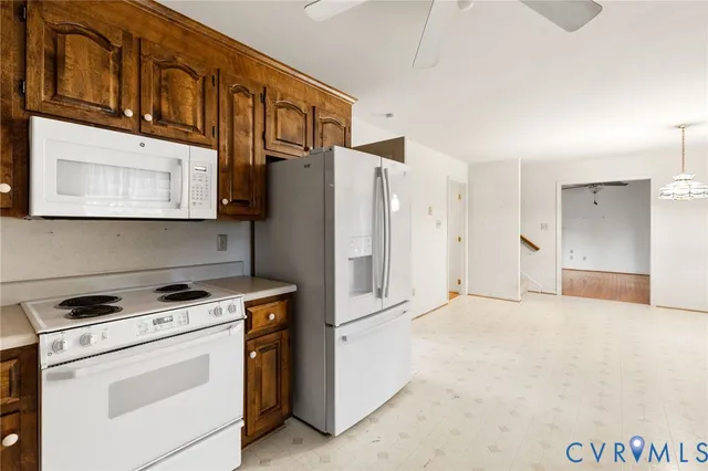 a kitchen with stainless steel appliances white cabinets and a refrigerator