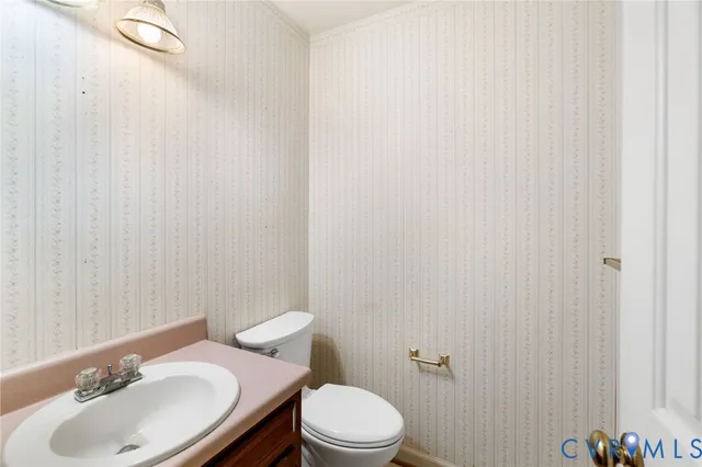 a bathroom with a sink toilet and a mirror