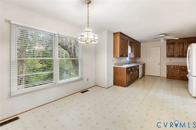 a view of a kitchen with a stove cabinets and a floor to ceiling window