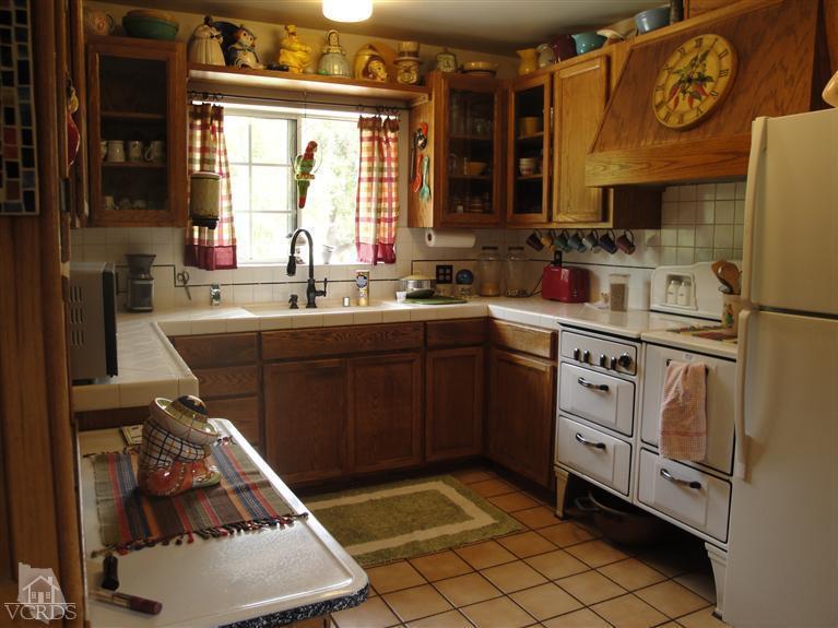 1925 South Rice Road Ojai, CA 93023 - Photo 3 of 14 a kitchen with stainless steel appliances a sink stove and refrigerator