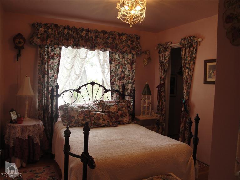 1925 South Rice Road Ojai, CA 93023 - Photo 8 of 14 a bedroom with a bed a dresser and a window