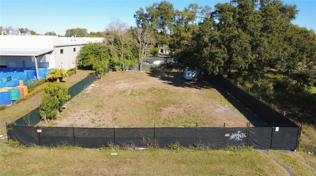 303 East Lancaster Road Orlando, FL 32809 - Photo 3 of 8 a view of a yard with wooden fence