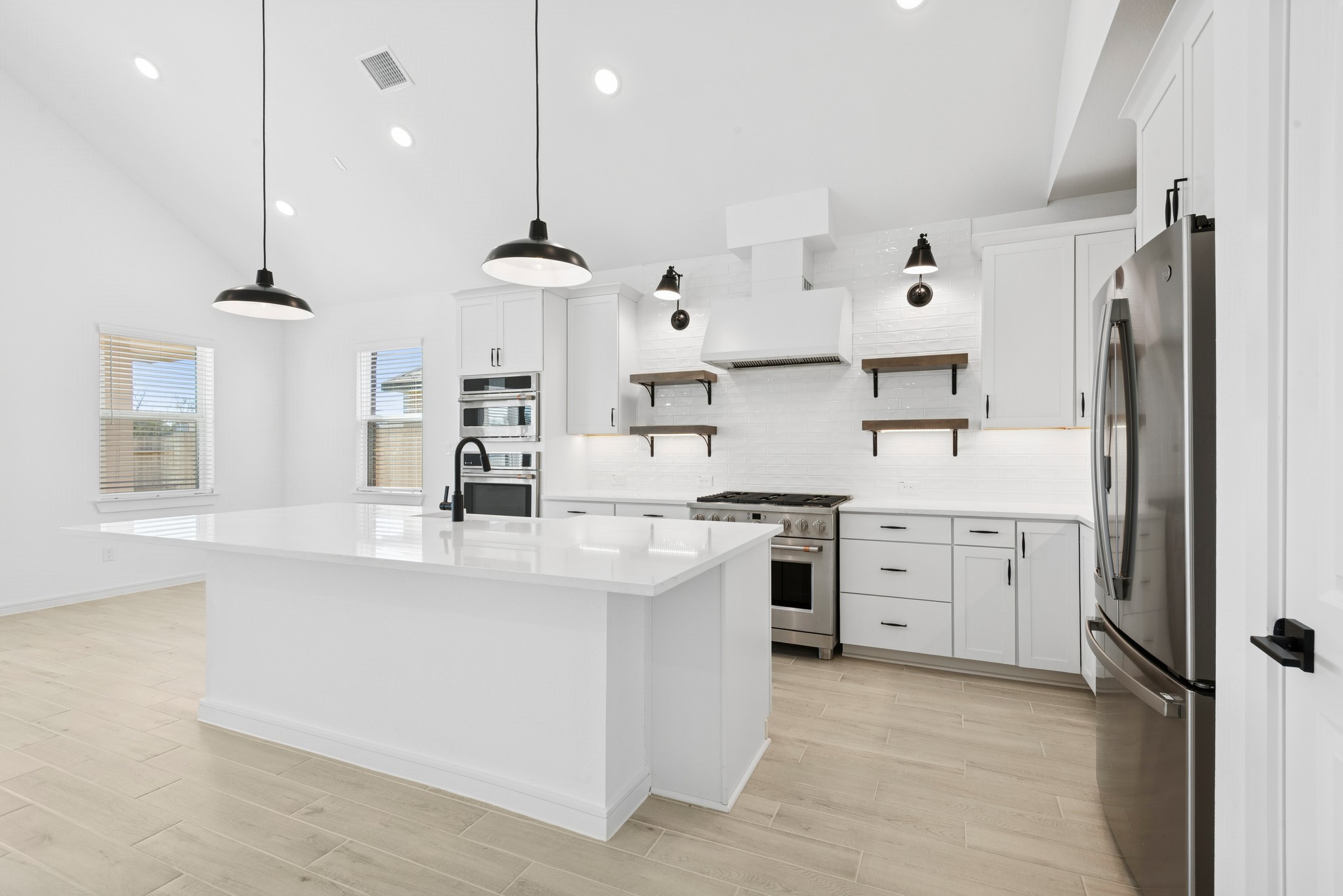 2606 Wastelbread Lane Rosenberg, TX 77471 - Photo 8 of 46 a kitchen with white cabinets and stainless steel appliances