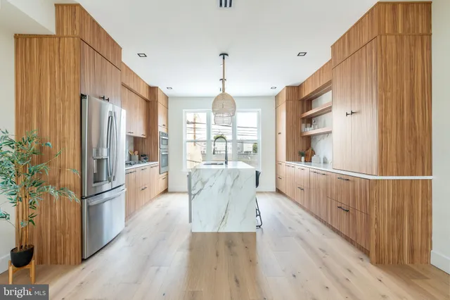 a open kitchen with white cabinets and stainless steel appliances