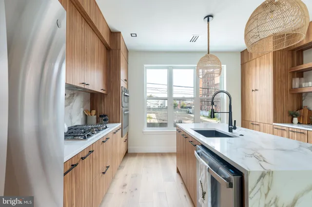 a kitchen with white cabinets and refrigerator