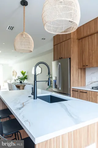 a bathroom with a shower sink vanity mirror and toilet