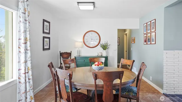 a view of a dining room with furniture and a chandelier