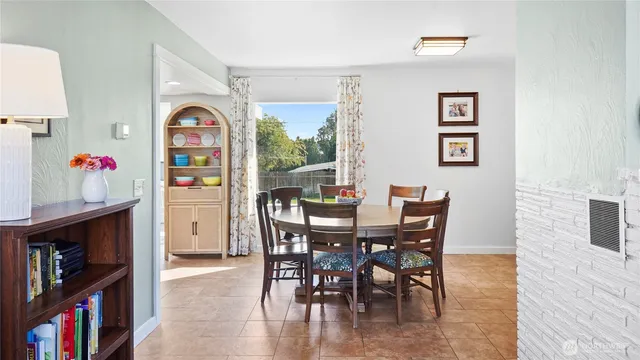 a view of a dining room with furniture and a book shelf