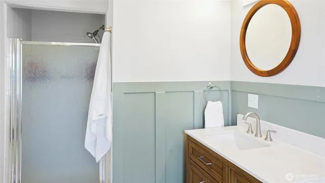 a bathroom with a sink vanity and a mirror