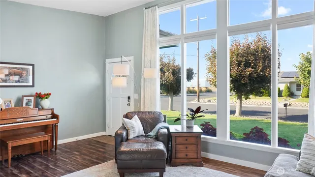 a living room with furniture and a floor to ceiling window