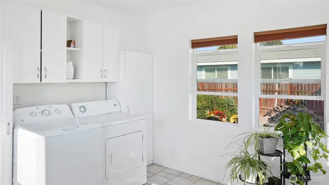 a living room filled with furniture and a potted plant