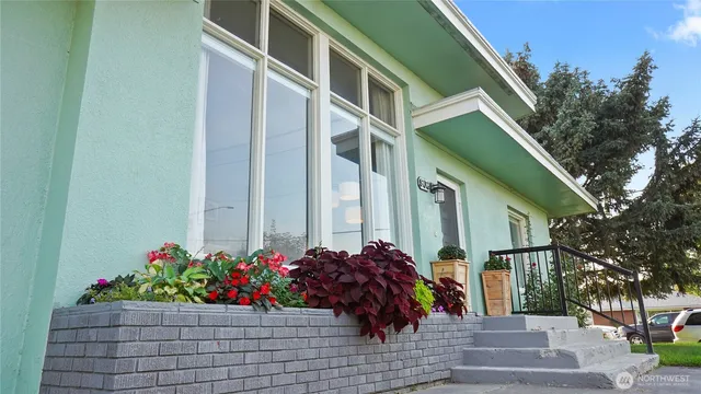 a front view of a house with a potted plant