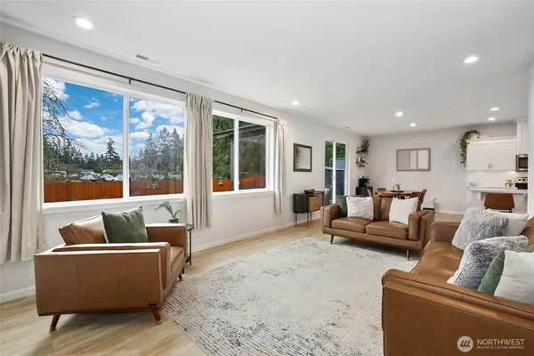 a living room with furniture and large windows
