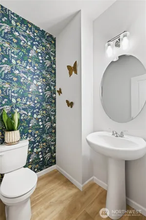 a bathroom with a sink toilet and mirror