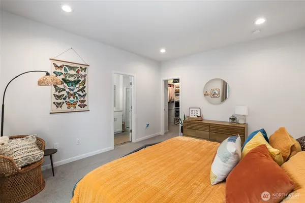 a bedroom with a bed and a large window