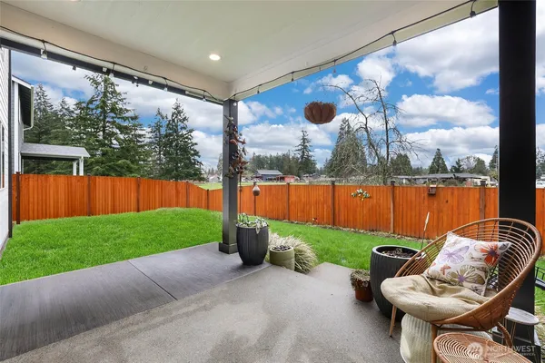 a view of a house with a patio and a yard