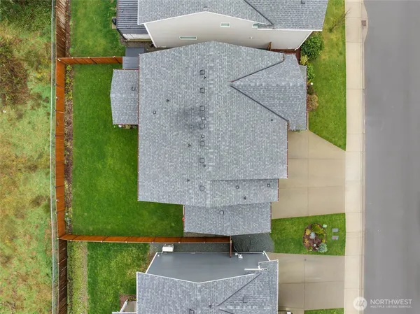 an aerial view of a house with a garden and lake view