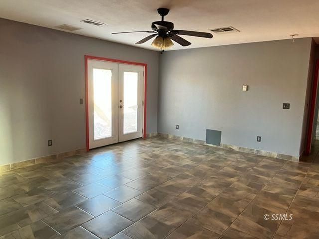 305 South Silver Ridge Street Ridgecrest, CA 93555 - Photo 8 of 32 a view of a livingroom with a ceiling fan window and a ceiling fan