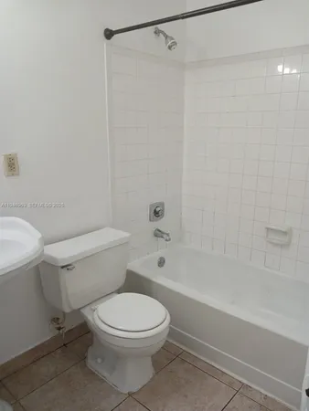 a bathroom with a toilet and a bathtub
