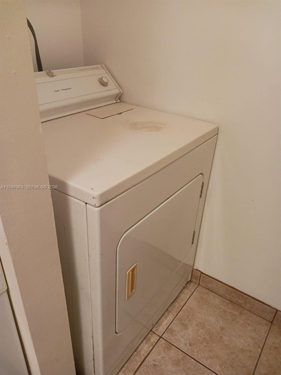 1239 Southwest 46th Avenue, Unit 903 Pompano Beach, FL 33069 - Photo 13 of 16 a utility room with dryer and washer