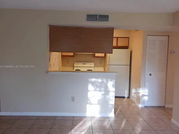 a view of a hallway with two windows