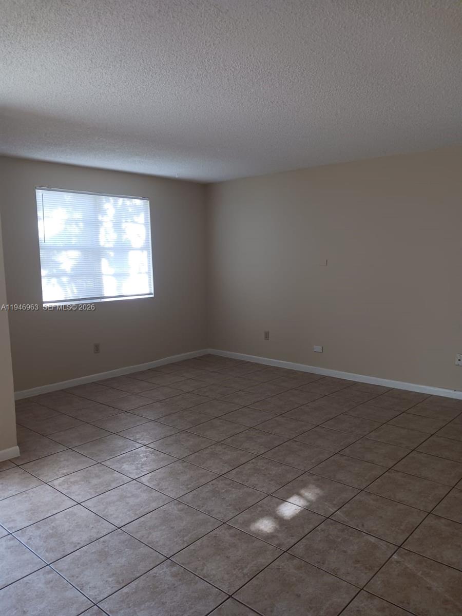 1239 Southwest 46th Avenue, Unit 903 Pompano Beach, FL 33069 - Photo 10 of 16 an empty room with windows