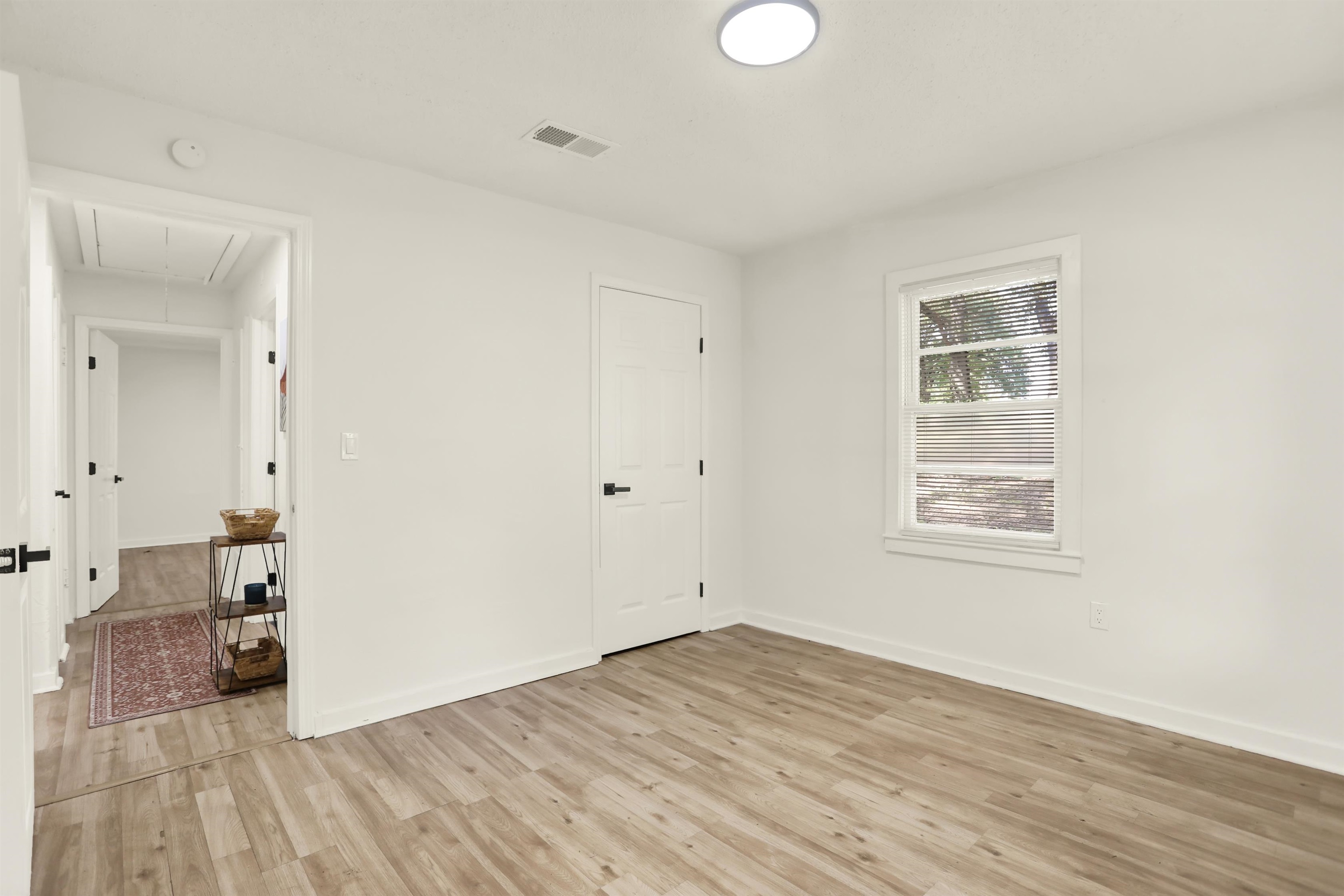 3393 Berea Road Memphis, TN 38109 - Photo 14 of 20 an empty room with wooden floor and windows
