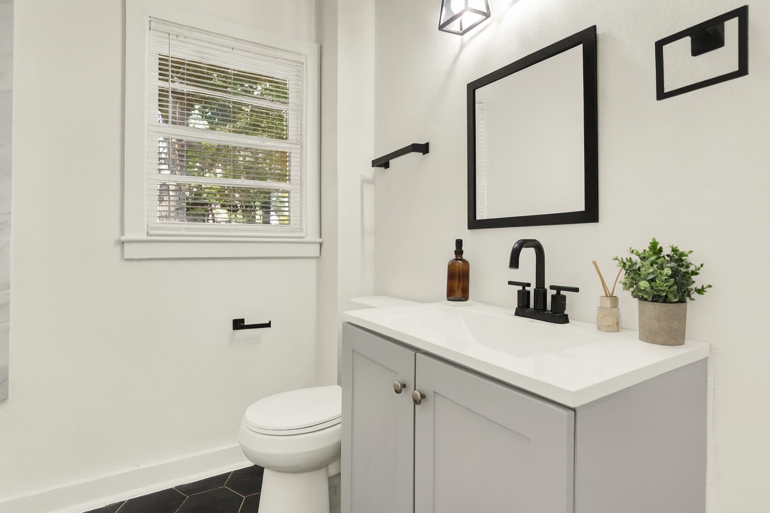 3393 Berea Road Memphis, TN 38109 - Photo 18 of 20 a bathroom with a sink toilet and a mirror