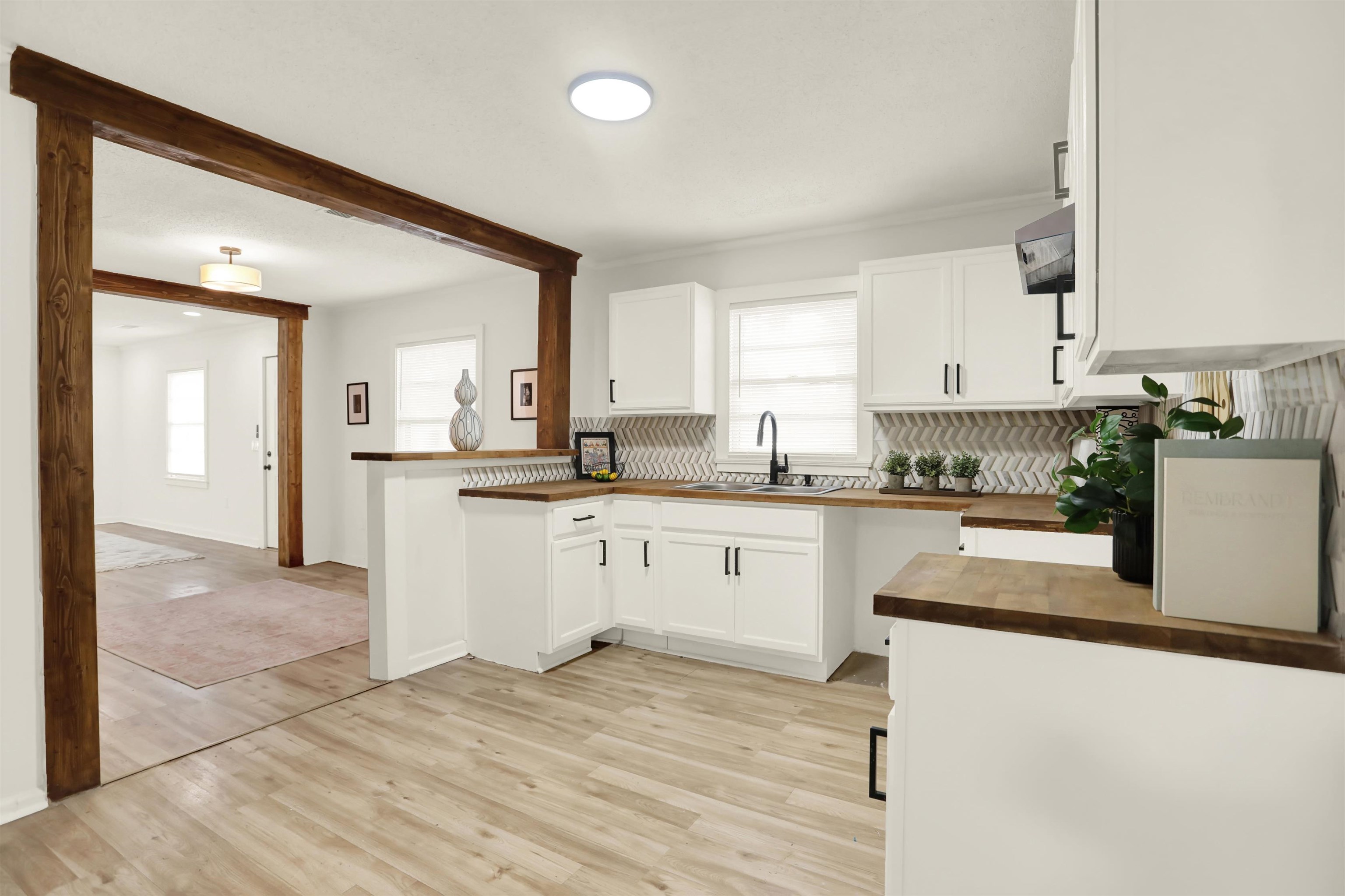 3393 Berea Road Memphis, TN 38109 - Photo 10 of 20 a kitchen with granite countertop white cabinets and white appliances