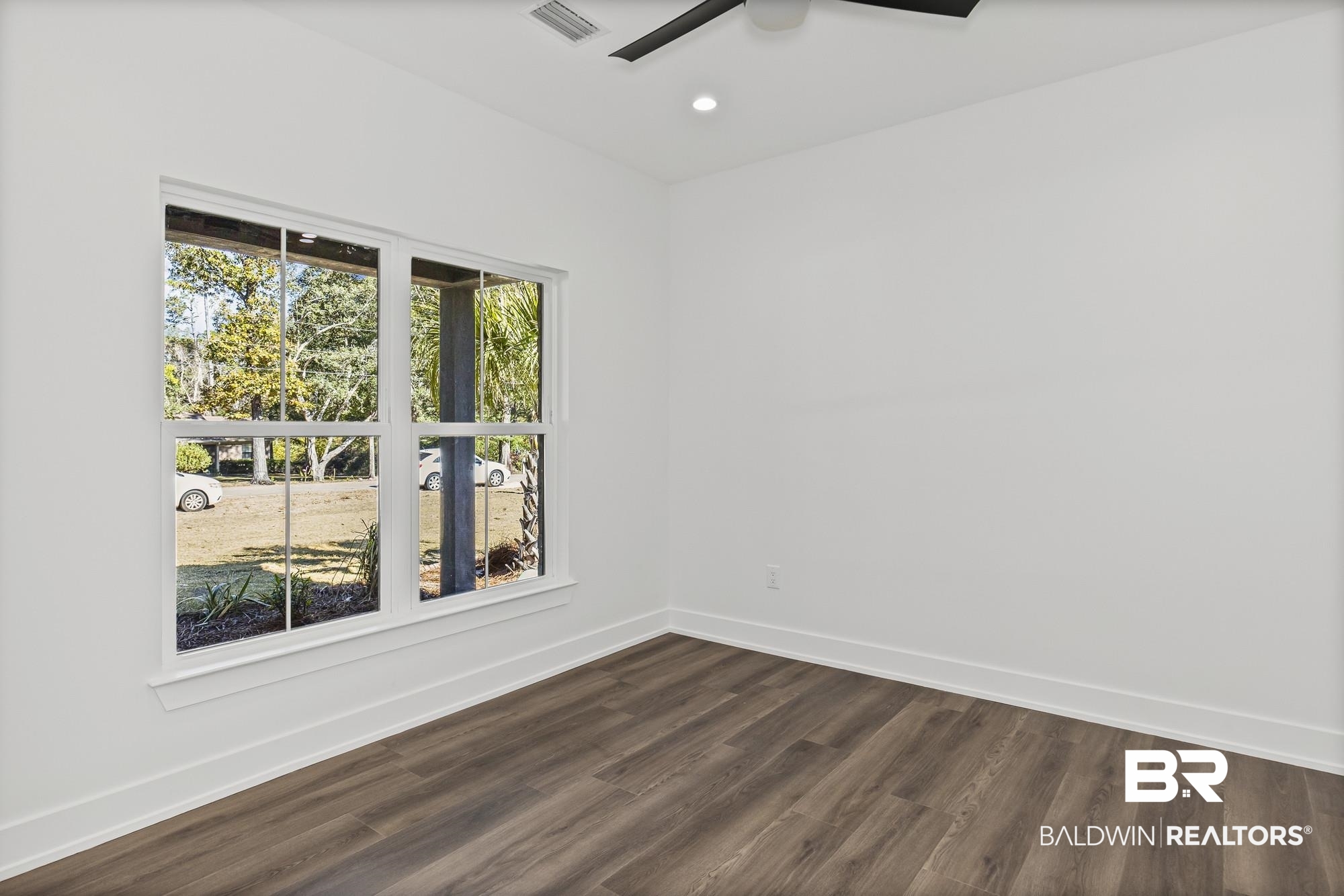10180 Pineview Drive Foley, AL 36535 - Photo 30 of 47 Empty room with dark wood-style floors and recessed lighting