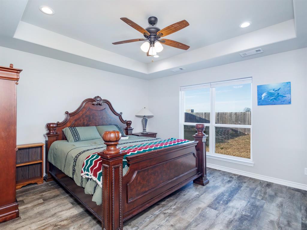 202 East Hall Court Early, TX 76802 - Photo 12 of 34 a bed sitting in a bedroom next to a window