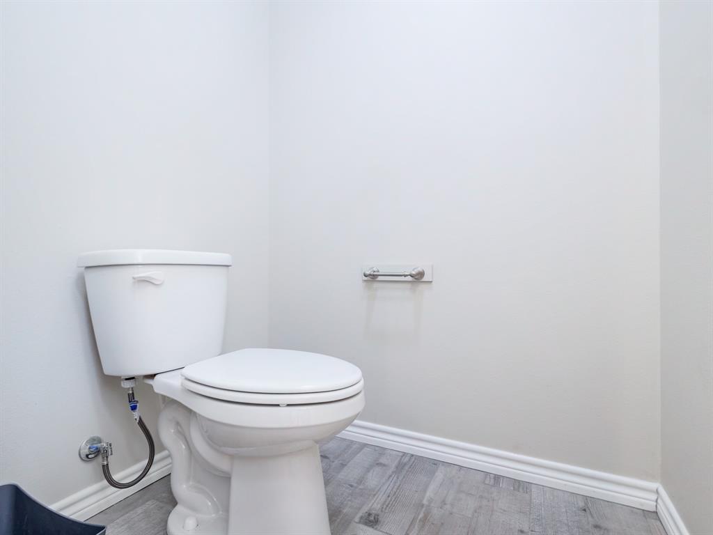 202 East Hall Court Early, TX 76802 - Photo 16 of 34 a bathroom with a toilet and a sink