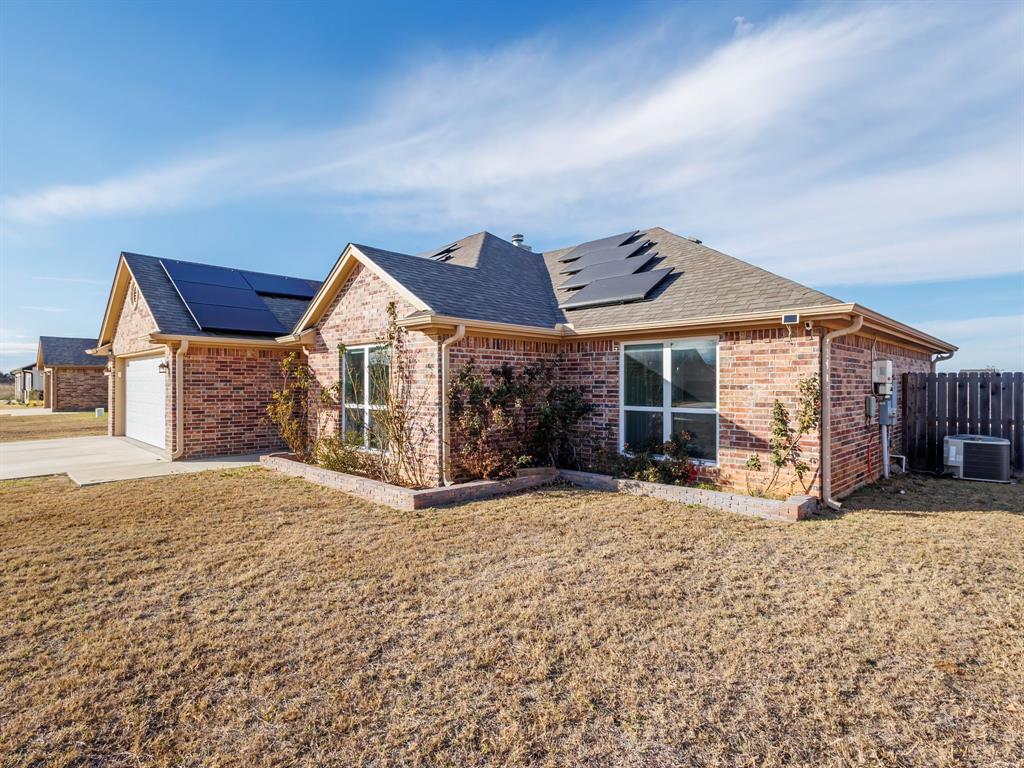 202 East Hall Court Early, TX 76802 - Photo 2 of 34 a view of a house with a yard and wooden fence