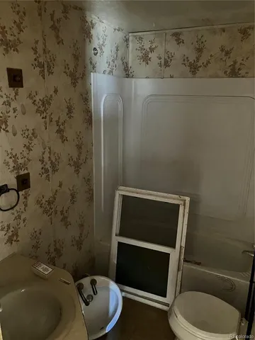 a bathroom with a toilet and a sink