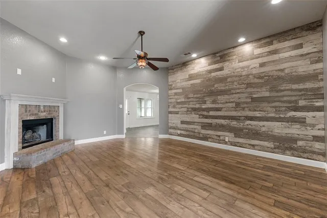 a view of an empty room with a fireplace and a window