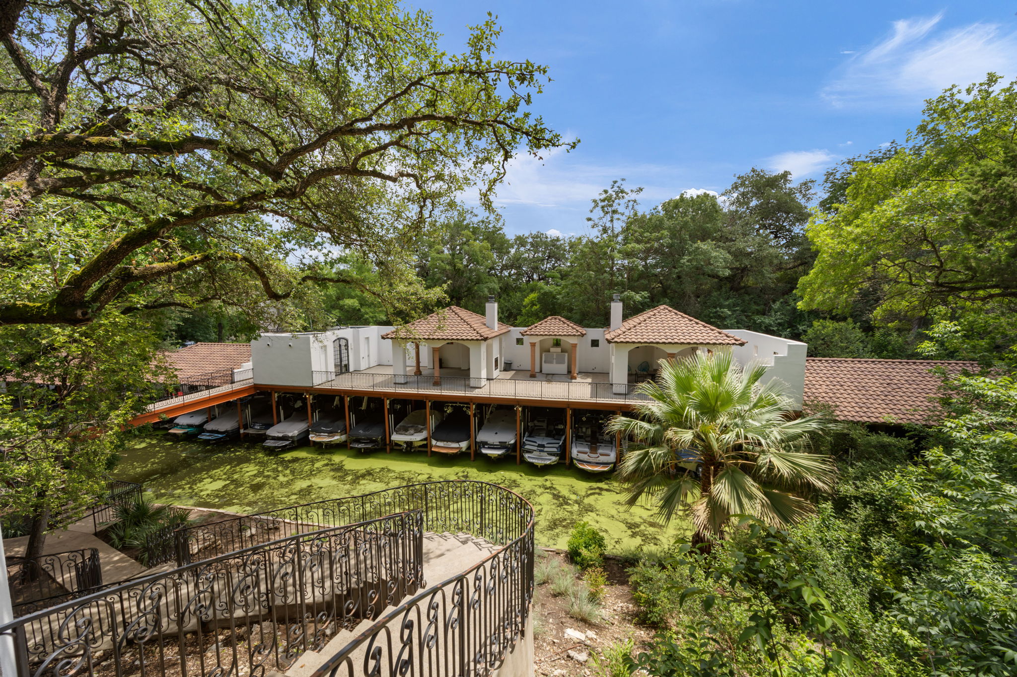 1910 Rue De St Tropez, Unit 6 Austin, TX 78746 - Photo 32 of 37 Boathouse with a private dock and ample storage for watercraft, offering direct access to the water.