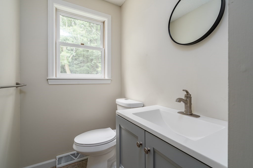 720 Russell Road, Unit C Westfield, MA 01085 - Photo 17 of 26 a bathroom with a sink a toilet and a mirror